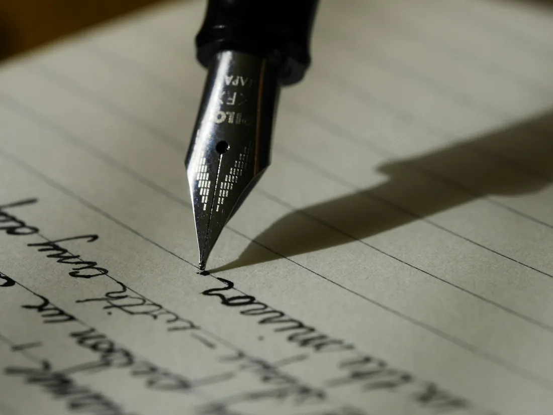 Fountain pen writing in an open notebook
