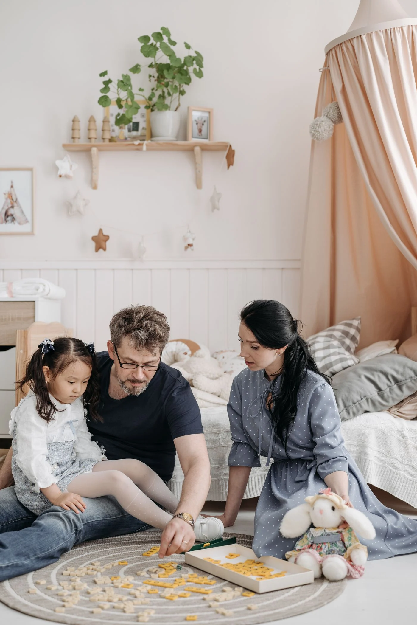 Family playing a board game together in a living room