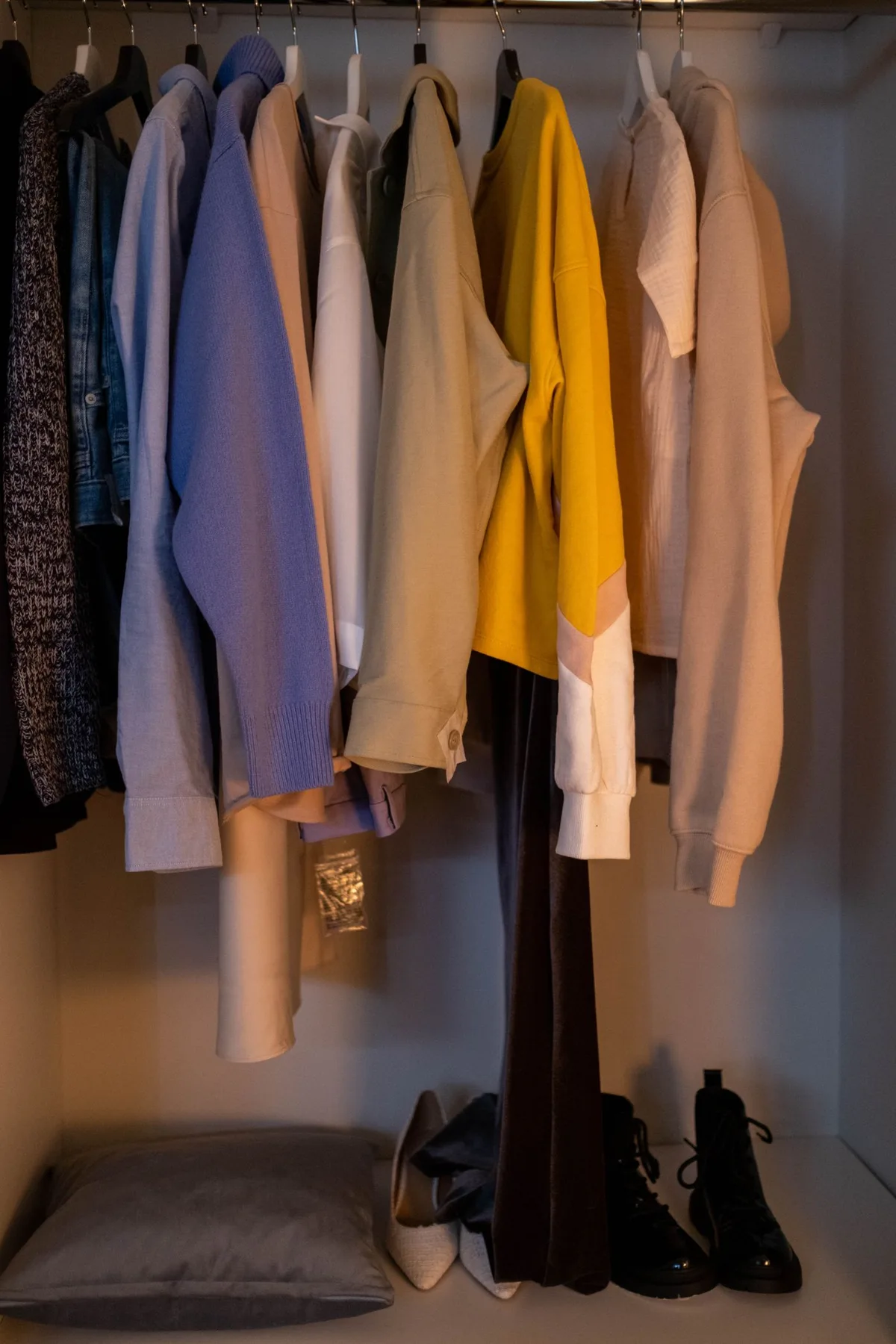 Clothing and footwear arranged inside a wardrobe