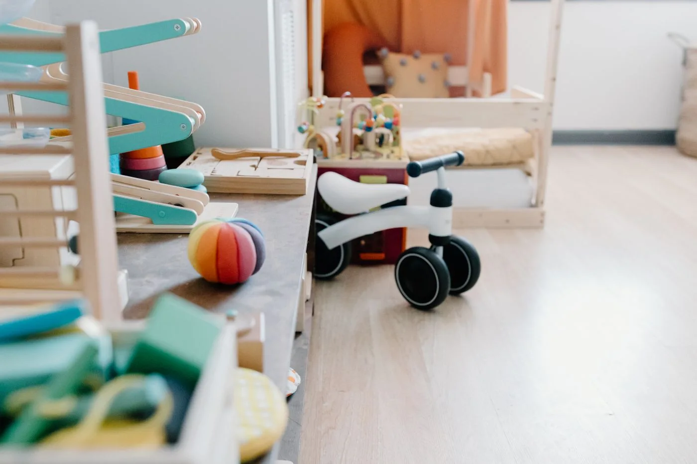 Wooden toys and a balance bike in a bright playroom